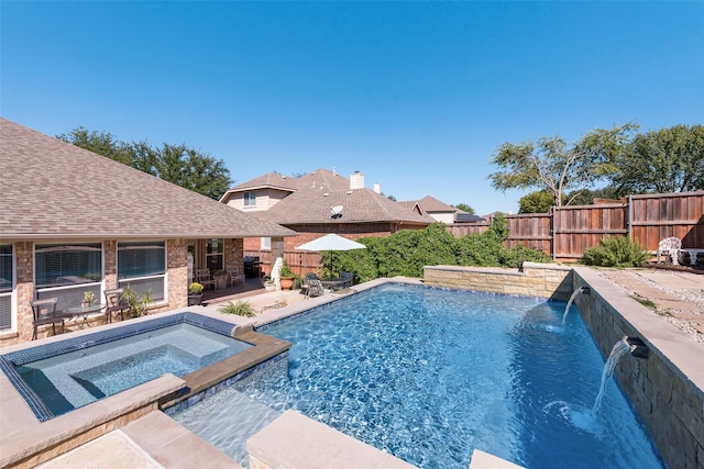 view of pool featuring pool water feature, a patio area, and an in ground hot tub