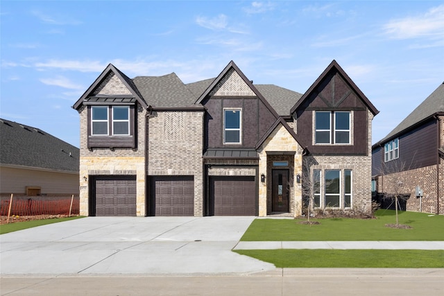 view of front of house with a garage and a front lawn