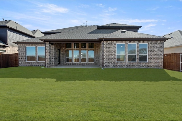 back of property featuring a yard and a patio