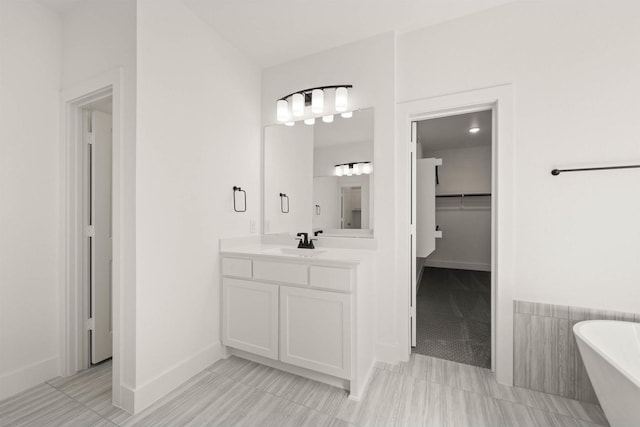 bathroom featuring vanity and a tub to relax in