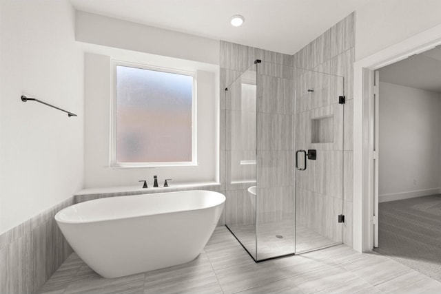 bathroom featuring separate shower and tub