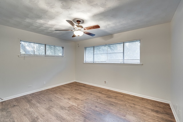 spare room featuring ceiling fan and hardwood / wood-style flooring