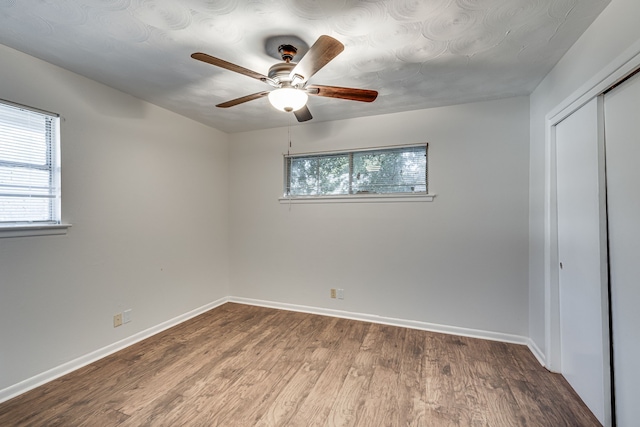 unfurnished bedroom featuring ceiling fan and hardwood / wood-style flooring