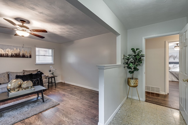 living room with wood-type flooring and ceiling fan