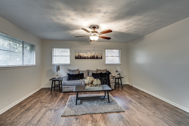 living room with dark hardwood / wood-style floors, ceiling fan, and plenty of natural light