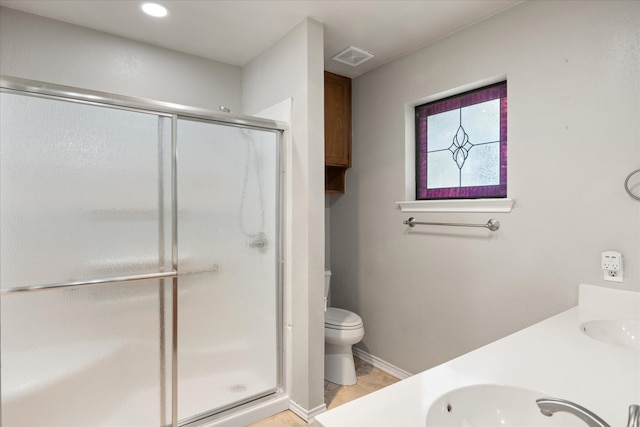 bathroom with an enclosed shower, vanity, and toilet