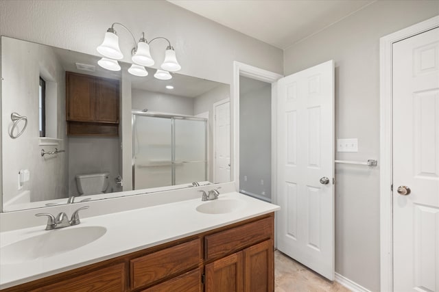 bathroom featuring walk in shower, vanity, and toilet