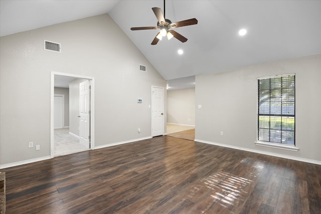 spare room featuring dark wood-type flooring, ceiling fan, and high vaulted ceiling