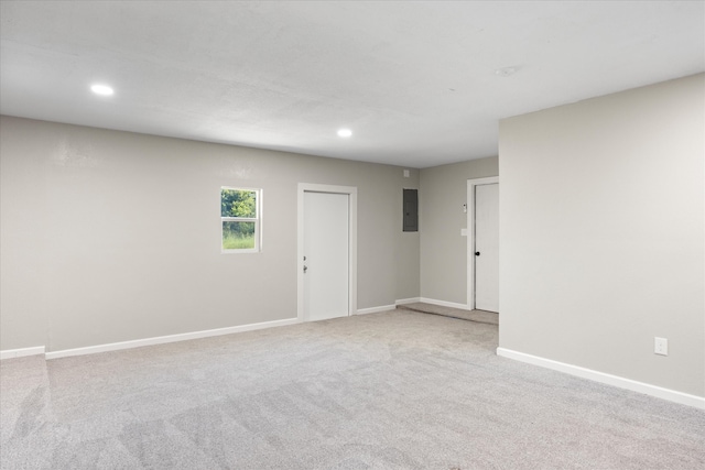 carpeted empty room featuring electric panel