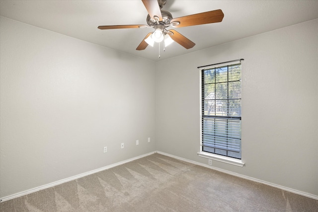 carpeted spare room featuring ceiling fan