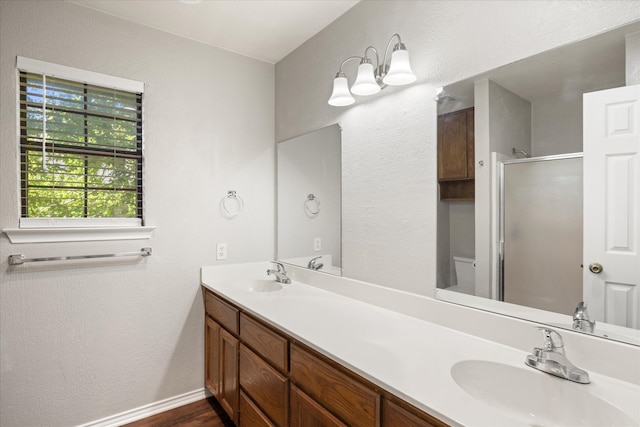 bathroom featuring a shower with shower door, vanity, toilet, and hardwood / wood-style flooring