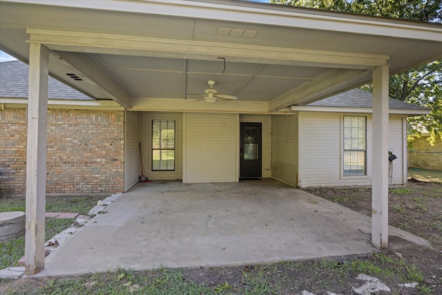 view of exterior entry featuring ceiling fan and a patio area