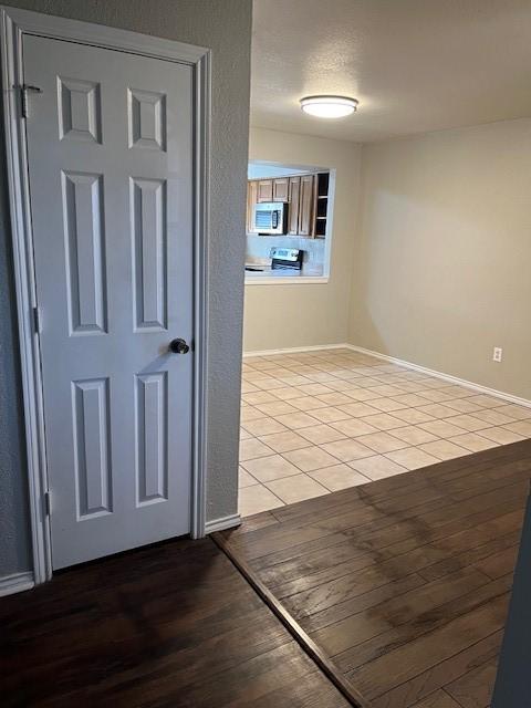 hallway featuring light tile patterned floors