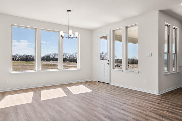 10 Louis Rd, Sherman, TX 75090 - unfurnished dining area with baseboards, a chandelier, and wood finished floors