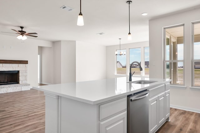 10 Louis Rd, Sherman, TX 75090 - kitchen with a fireplace, wood finished floors, a sink, visible vents, and dishwasher