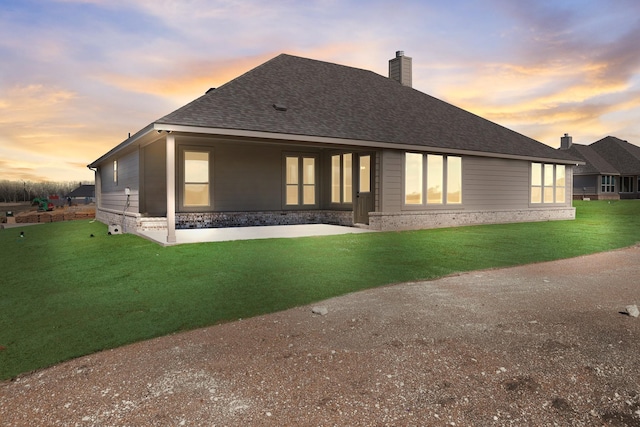 10 Louis Rd, Sherman, TX 75090 - rear view of property featuring a shingled roof, a lawn, and a chimney