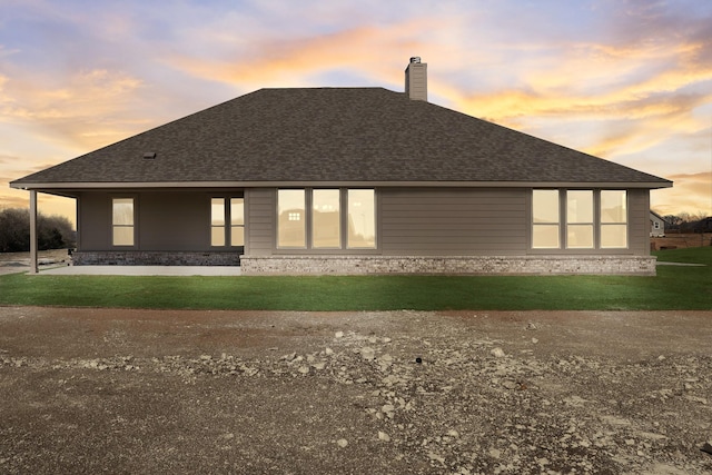 10 Louis Rd, Sherman, TX 75090 - rear view of house featuring a shingled roof, a lawn, and a chimney