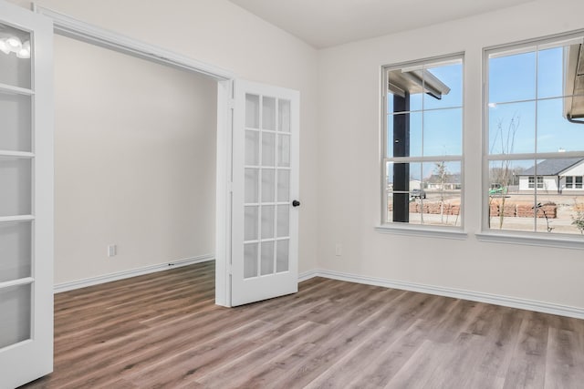 10 Louis Rd, Sherman, TX 75090 - empty room with built in shelves, wood finished floors, and baseboards