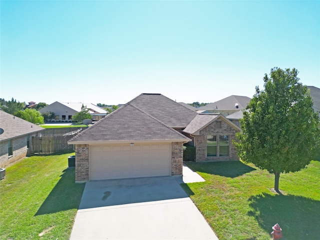 view of front facade with a garage and a front lawn