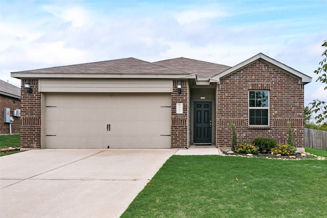 single story home featuring a garage and a front yard