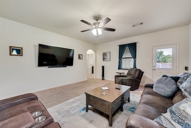 carpeted living room with ceiling fan