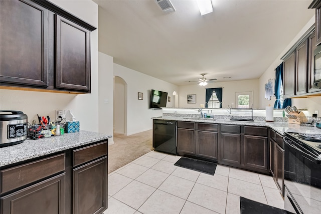 kitchen with ceiling fan, light tile patterned flooring, sink, dark brown cabinets, and black appliances