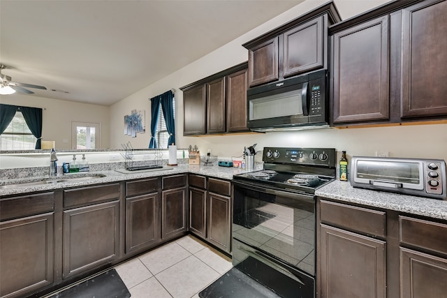 kitchen with sink, black appliances, light tile patterned floors, dark brown cabinetry, and ceiling fan