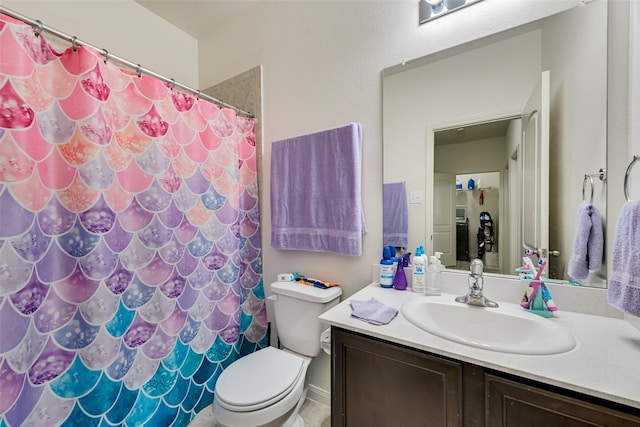 bathroom with a shower with curtain, vanity, and toilet