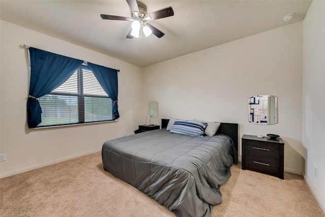 bedroom with ceiling fan and light colored carpet