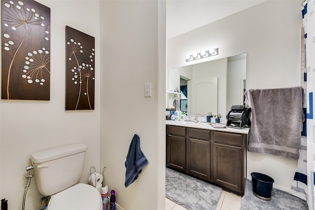 bathroom featuring tile patterned floors, vanity, and toilet