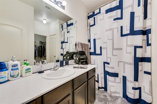 bathroom with a shower with shower curtain and vanity