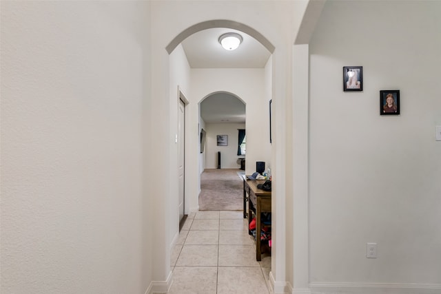 hall featuring light tile patterned floors