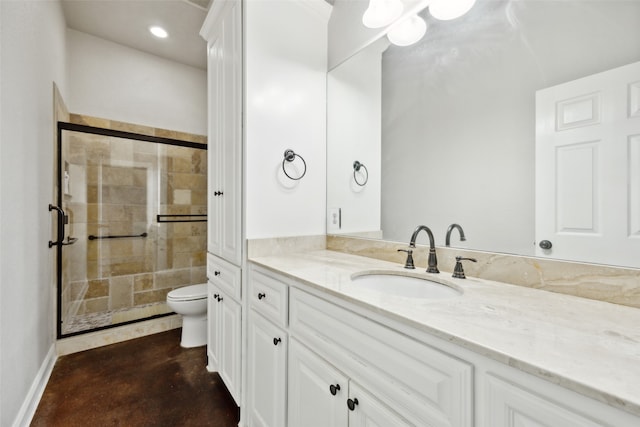 bathroom with vanity, toilet, concrete flooring, and a shower with door