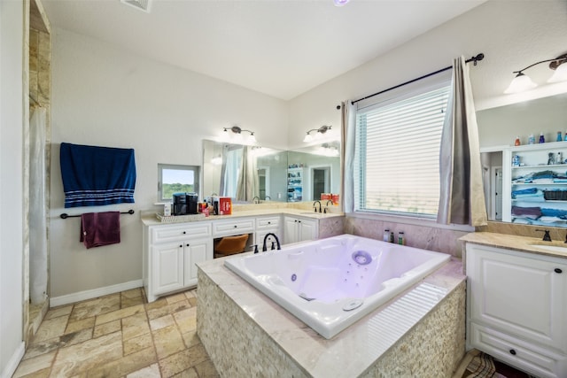 bathroom with vanity and separate shower and tub