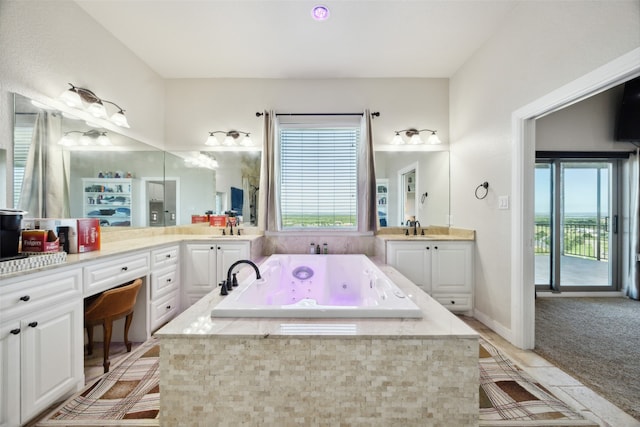 bathroom featuring vanity and a relaxing tiled tub