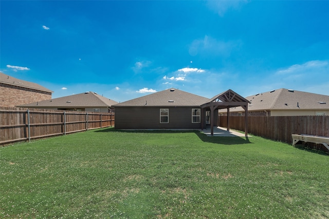 back of house with a yard and a patio area