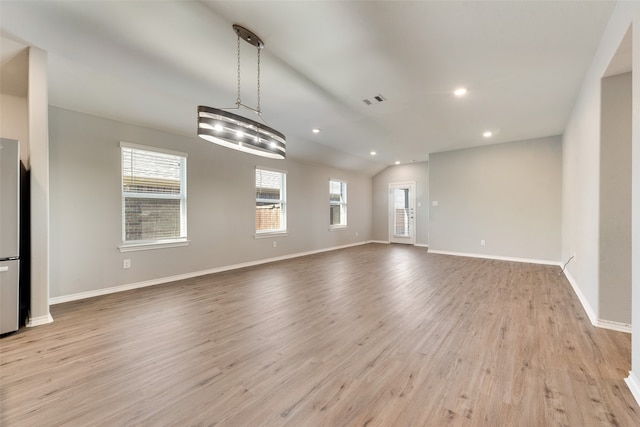 interior space with light hardwood / wood-style floors and lofted ceiling