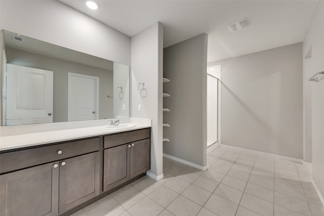 bathroom featuring tile patterned flooring, vanity, and a shower with shower door