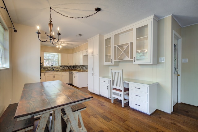 kitchen with dishwasher, white cabinetry, dark hardwood / wood-style flooring, and sink