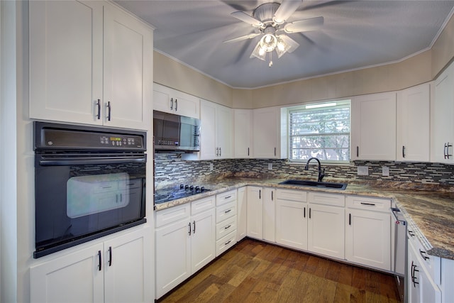 kitchen featuring ornamental molding, sink, white cabinetry, black appliances, and dark hardwood / wood-style floors