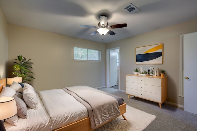 bedroom featuring ceiling fan, ensuite bathroom, and carpet floors