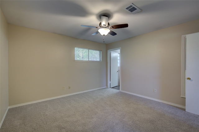 empty room with ceiling fan and light colored carpet