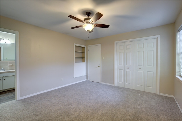 unfurnished bedroom with a closet, ceiling fan, and carpet floors