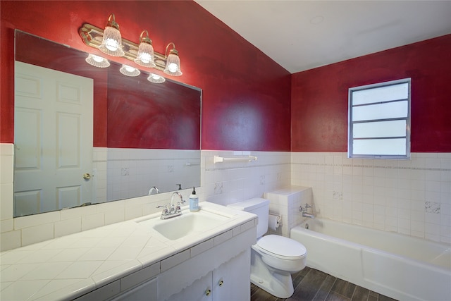 bathroom with tile walls, a bathtub, hardwood / wood-style floors, vanity, and toilet