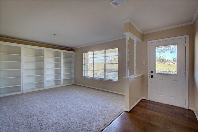 entrance foyer with ornamental molding, plenty of natural light, and dark hardwood / wood-style flooring