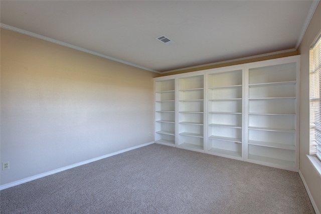 empty room with ornamental molding and carpet floors