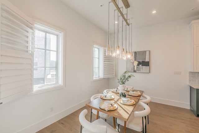 dining space with recessed lighting, baseboards, and wood finished floors