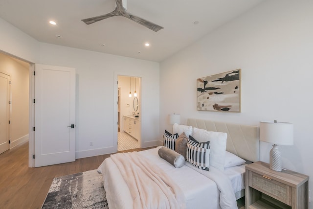 bedroom featuring connected bathroom, baseboards, wood finished floors, and recessed lighting