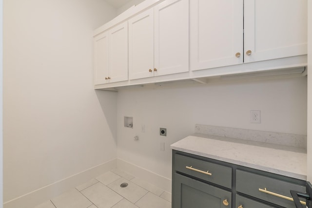 washroom featuring cabinet space, light tile patterned floors, baseboards, hookup for an electric dryer, and washer hookup