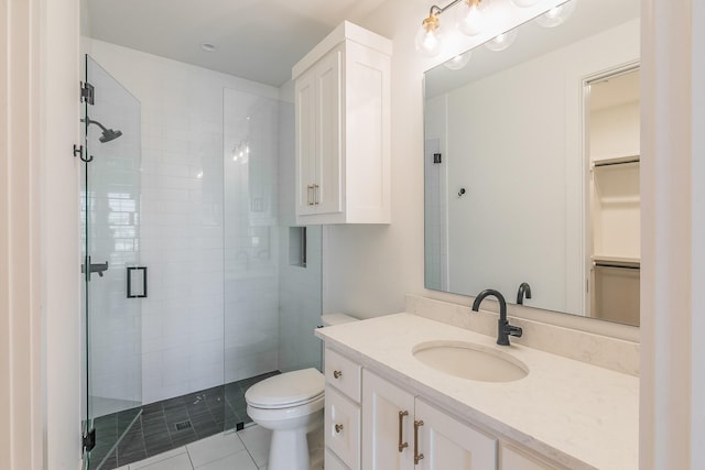 full bath featuring a stall shower, vanity, toilet, and tile patterned floors